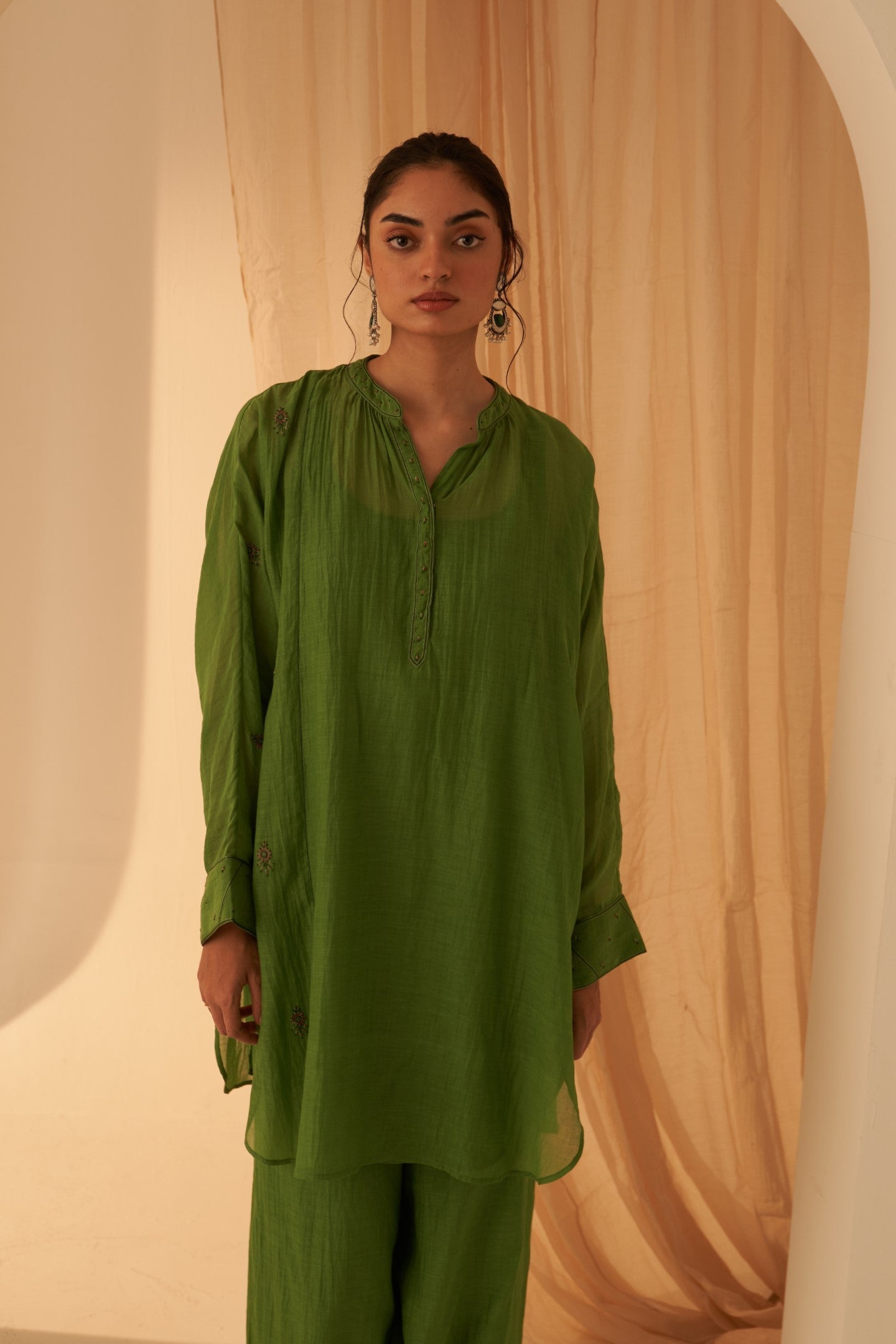 Green chanderi resham buti embroidered tunic paired with cotton slip & salwar