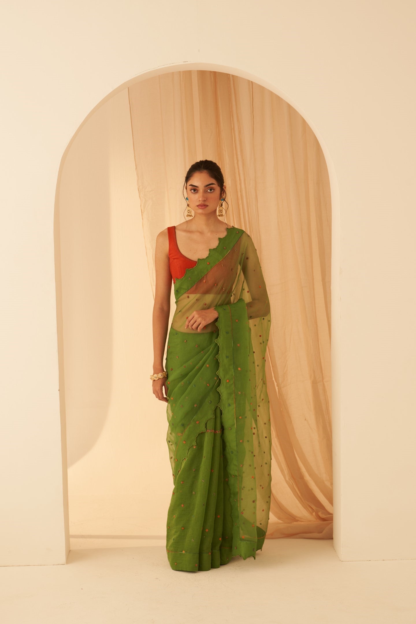 Green chanderi-organza  embroidered with cross taanka work, scalloped border saree paired with an organic cotton stitched petticoat