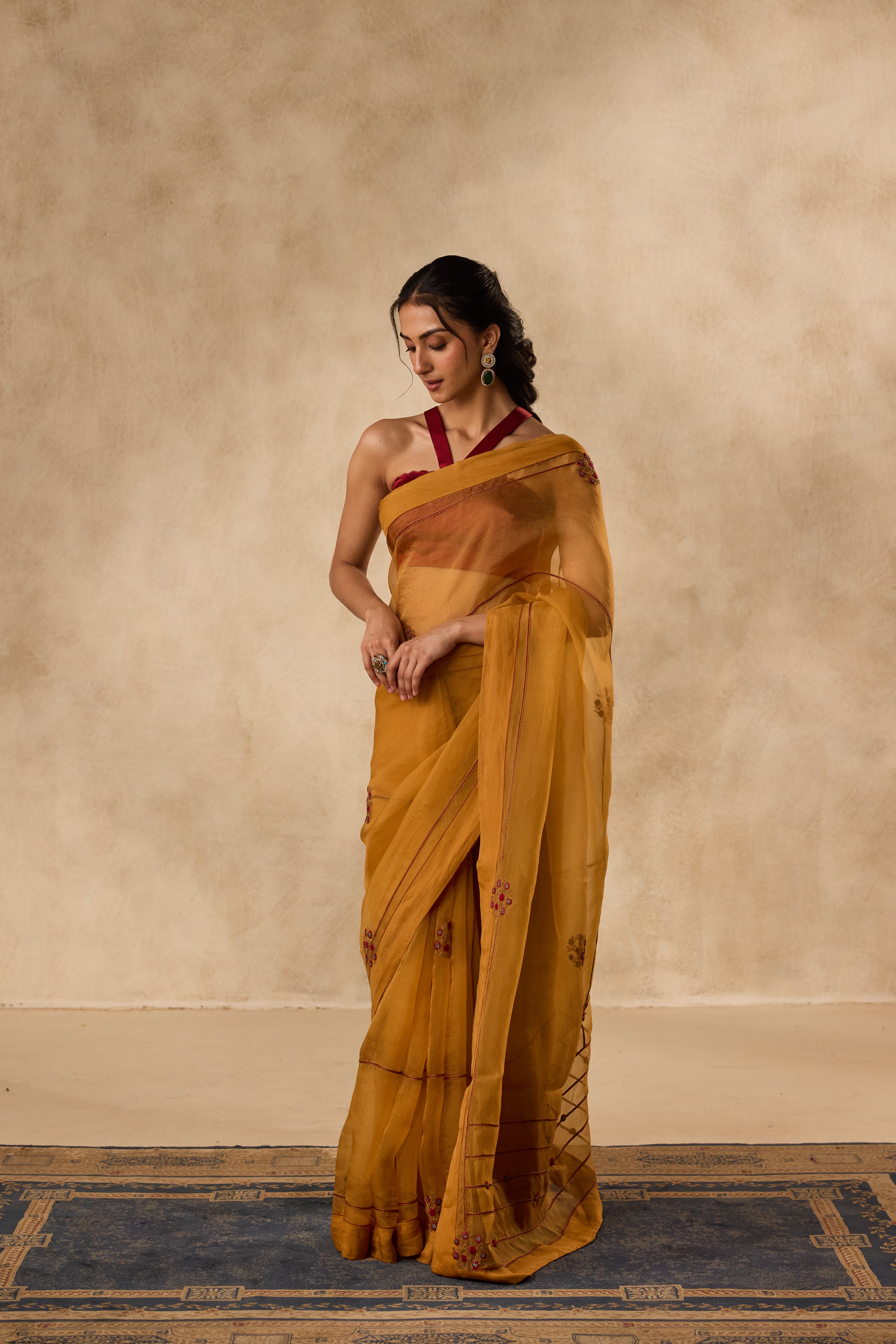 Mustard embroidered organza saree paired with unstitched & unembroidered blouse fabric