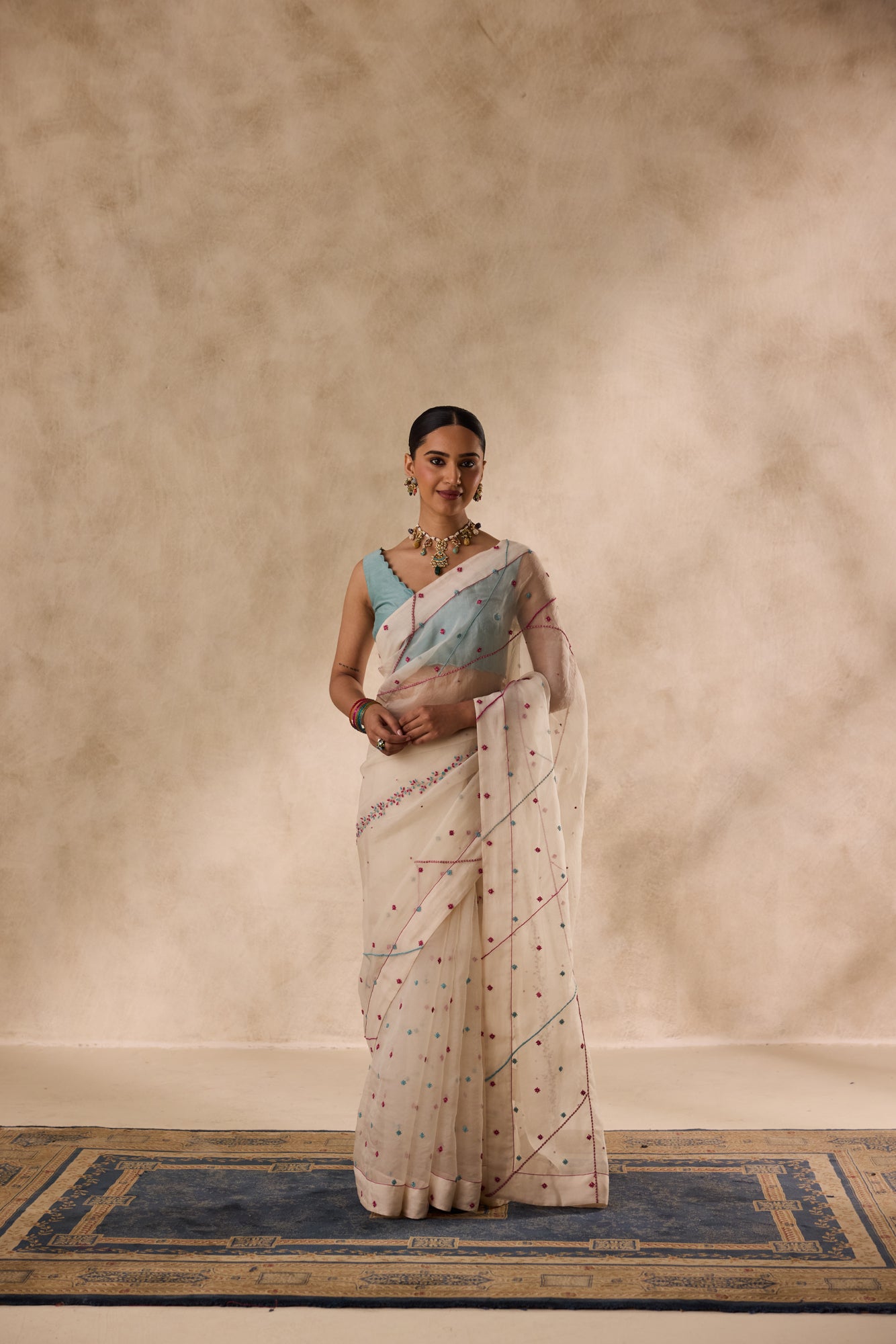 Ivory organza french knot cross stitch embroidered saree comes with unstitched & unembroidered blouse fabric in chanderi