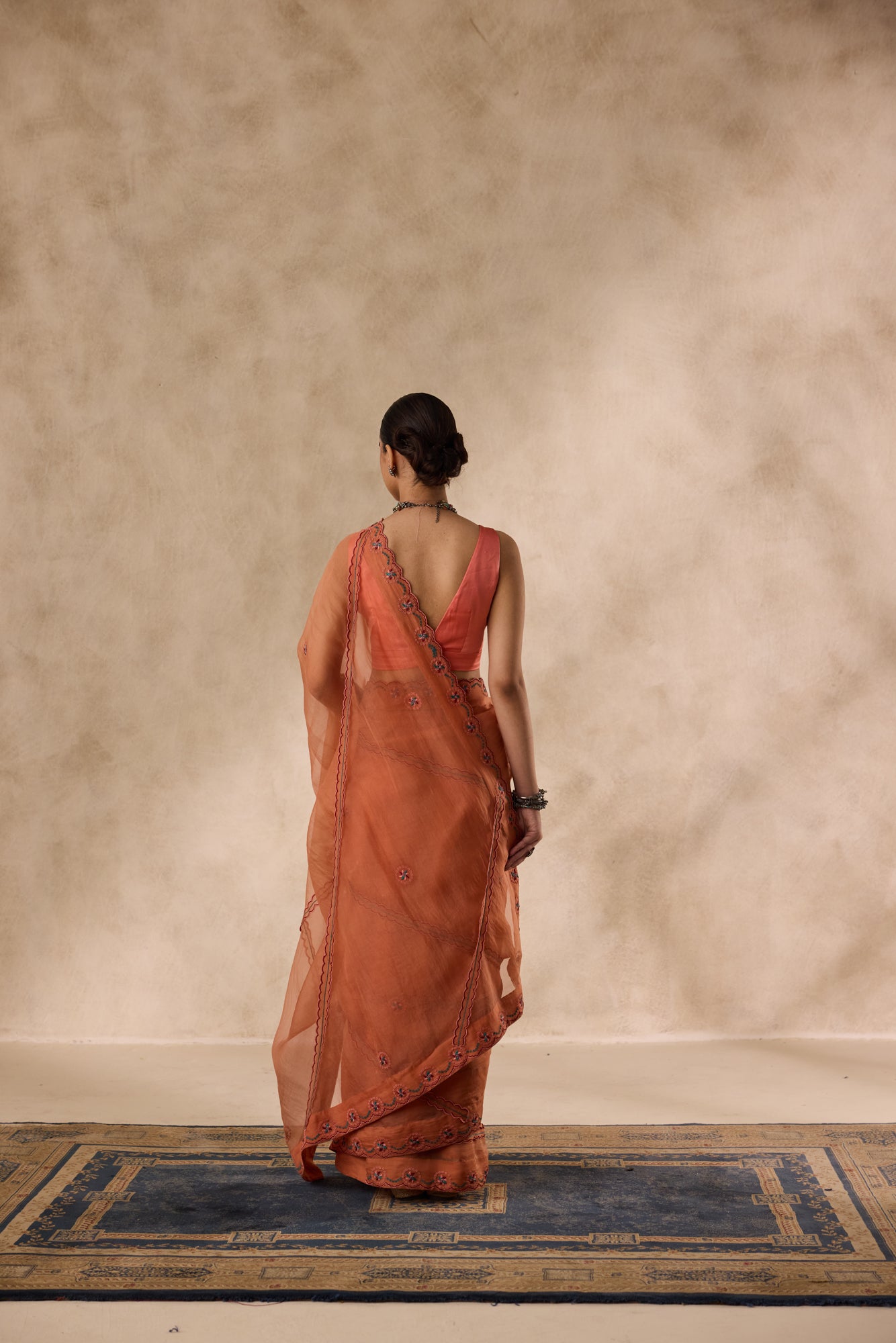 Peach organza scalloped embroidered saree comes with unstitched & unembroidered blouse fabric in chanderi
