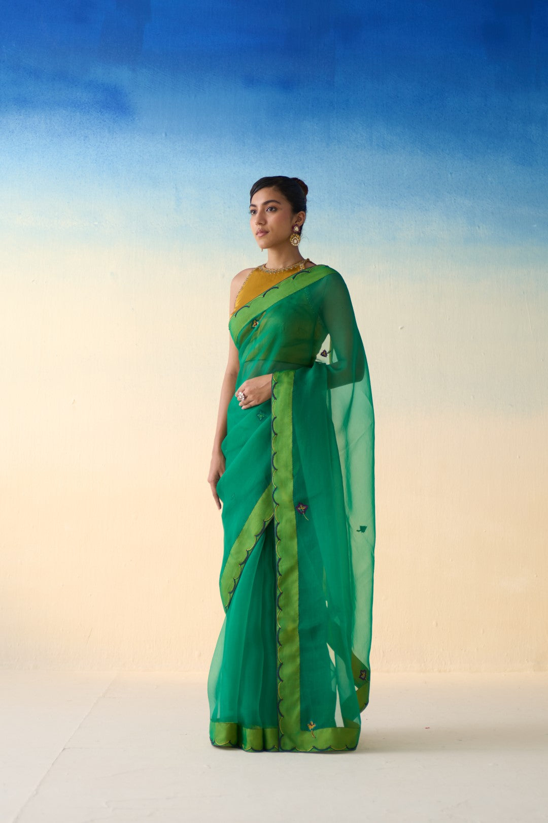 Green organza embroidered & scallop border saree comes with an organic cotton petticoat. (02 Pcs.)