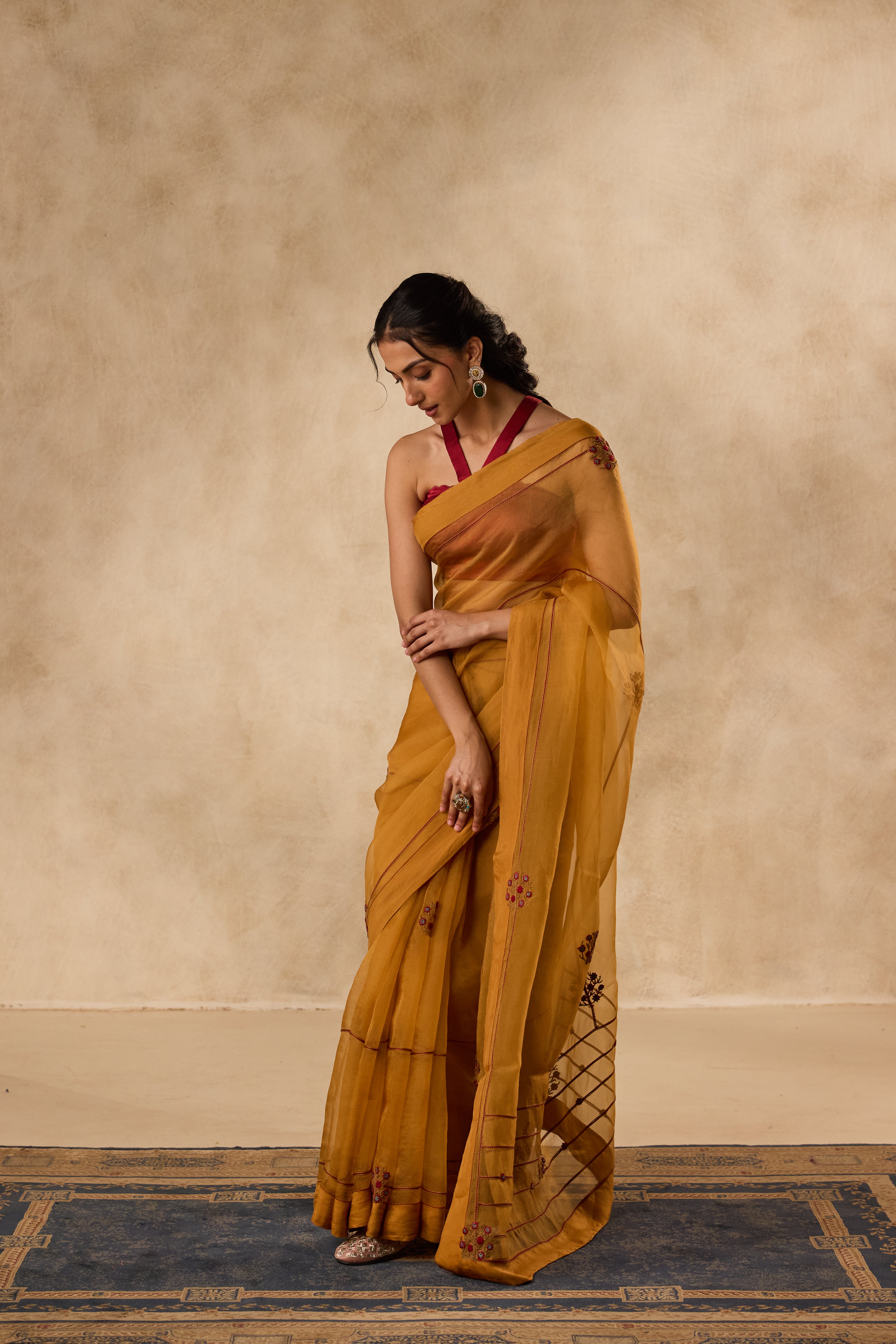 Mustard embroidered organza saree paired with unstitched & unembroidered blouse fabric