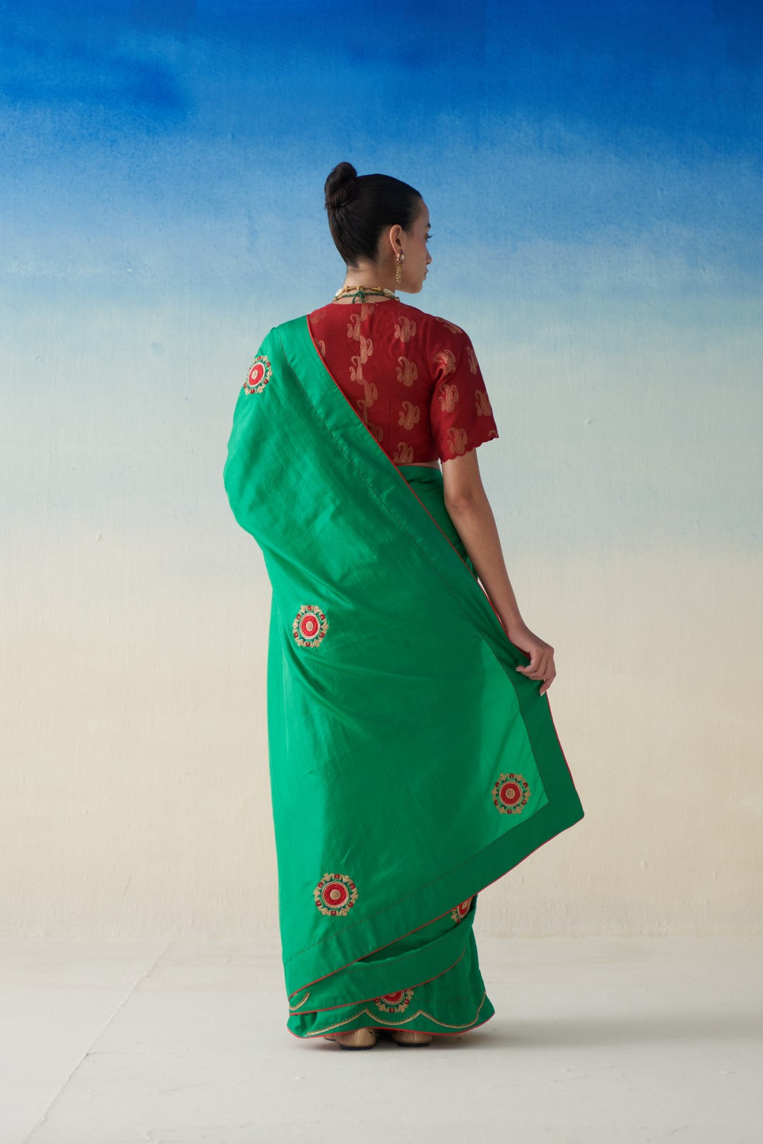 Green silk saree with embroidered motifs comes with an organic cotton stitched petticoat (02 Pcs.)