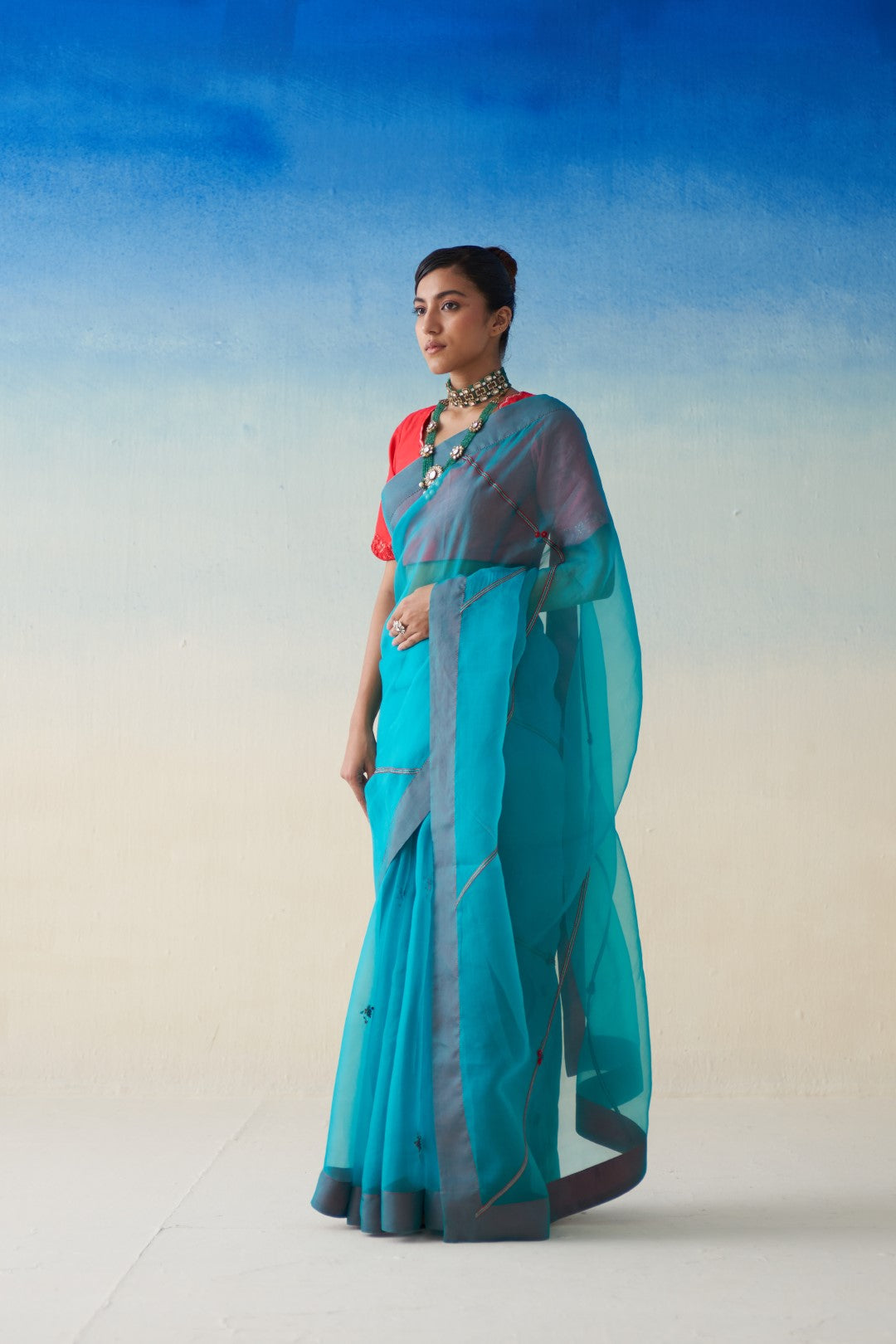 Turquoise organza embroidered saree comes with an organic cotton stitched petticoat (02 Pcs.)