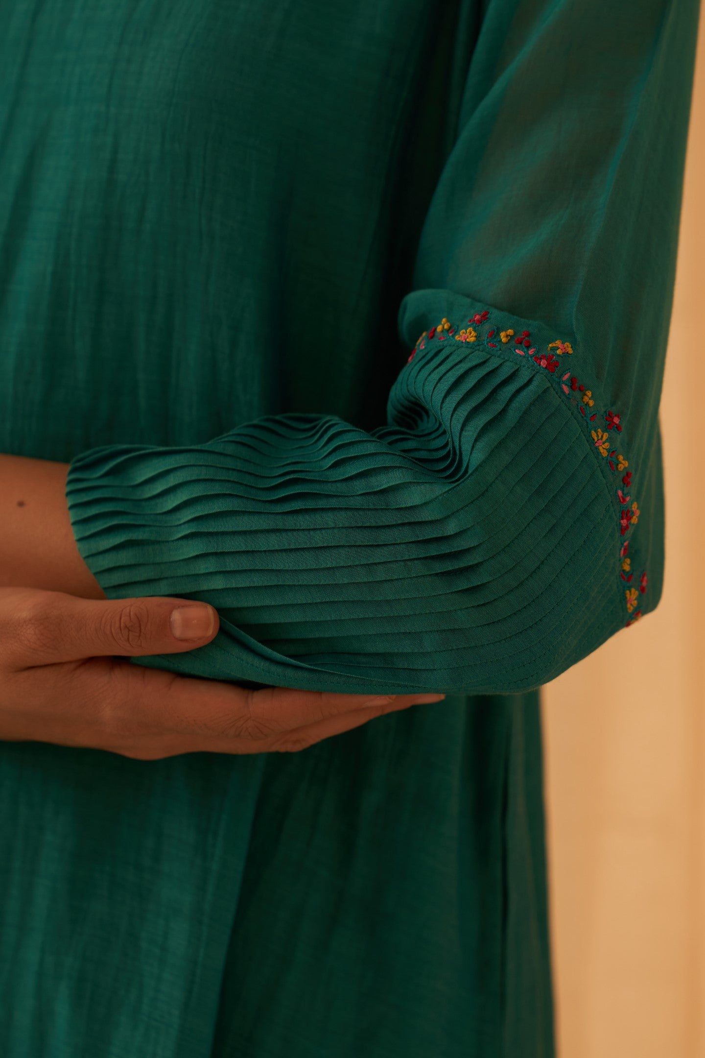 Turquoise chanderi kurta with pintuck box pleats and floral work on sleeves paired with pant & organza dupatta