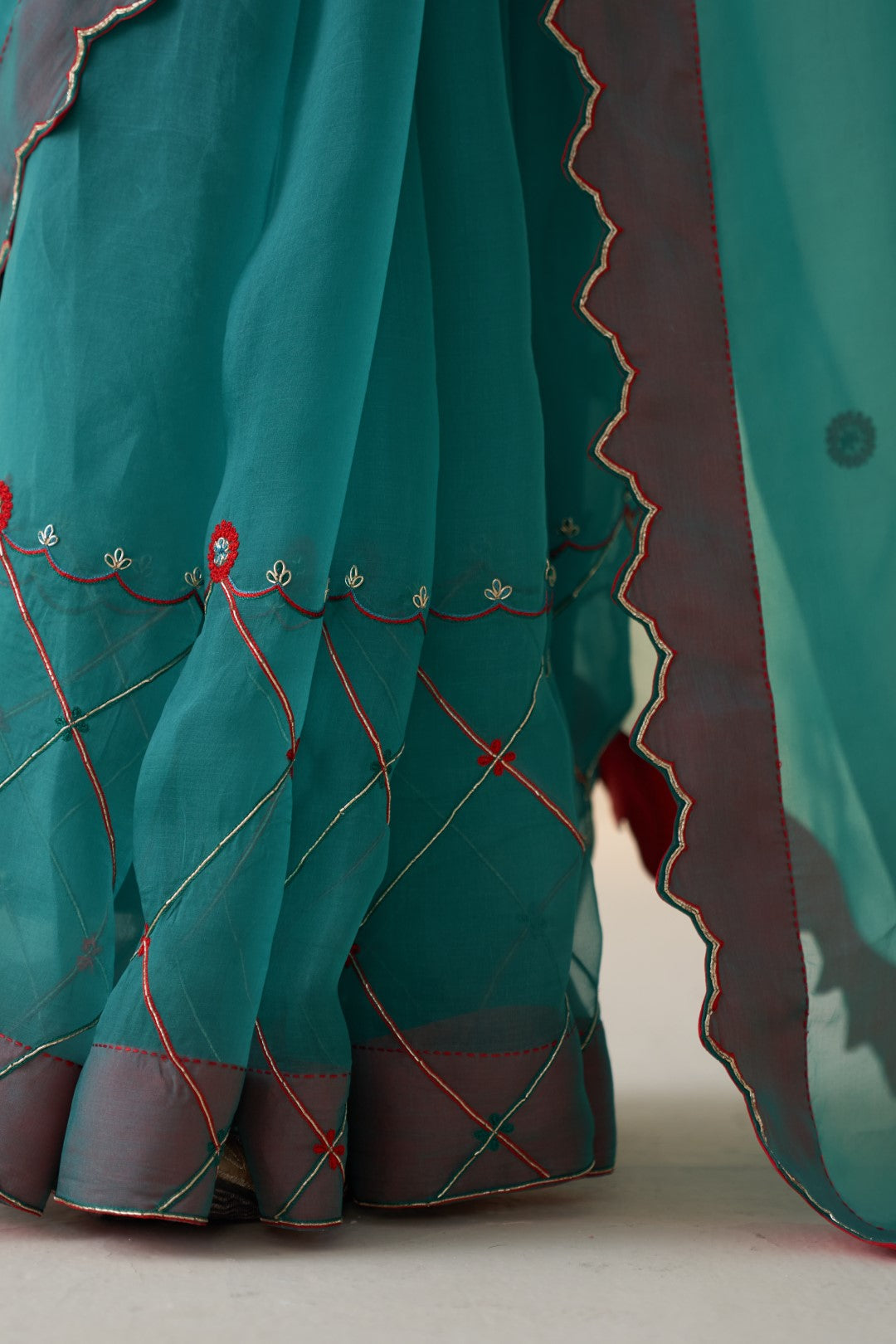 Turquoise organza checkered jaal-embroidered saree comes with an organic cotton stitched petticoat (02 Pcs.)