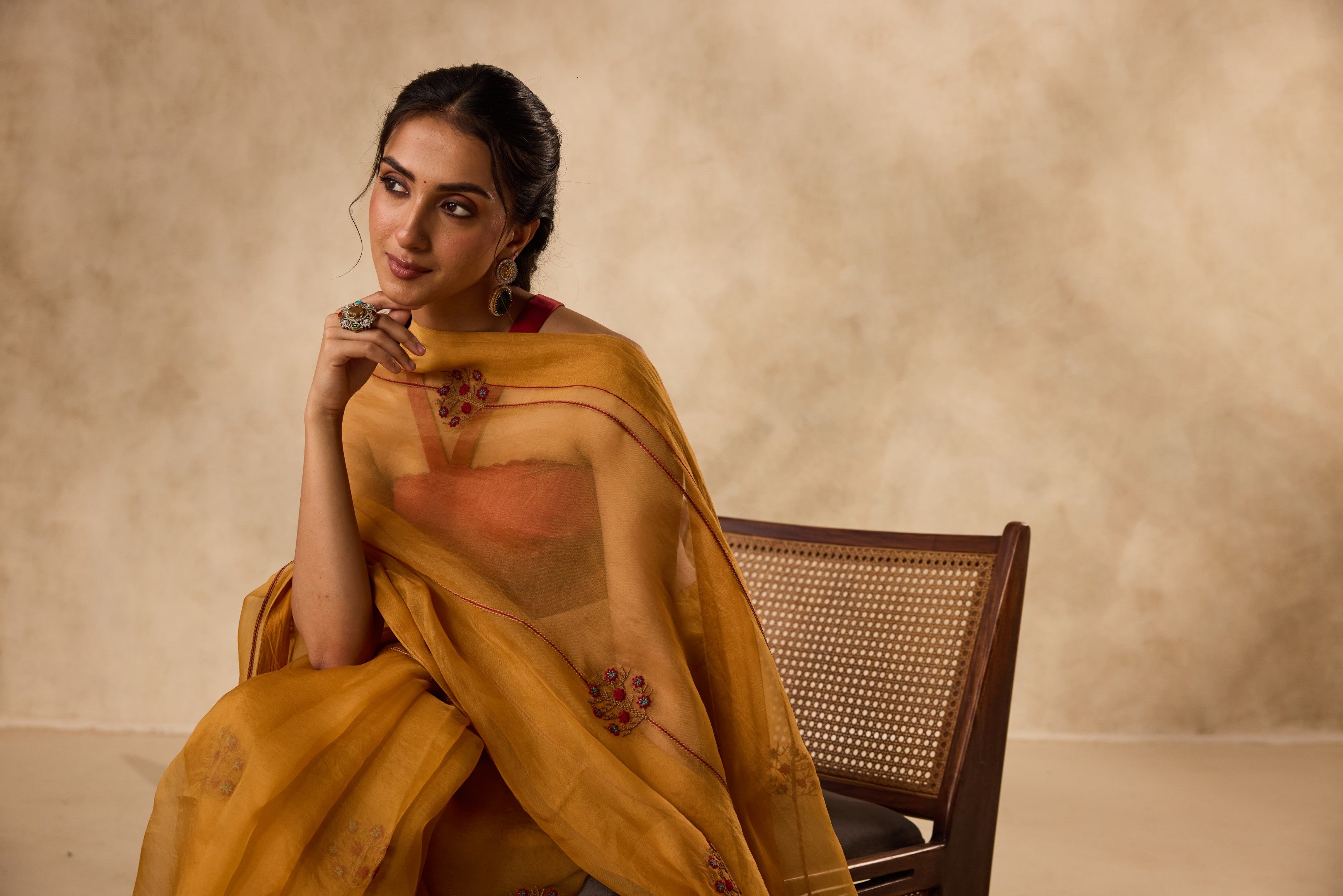 Mustard embroidered organza saree paired with unstitched & unembroidered blouse fabric