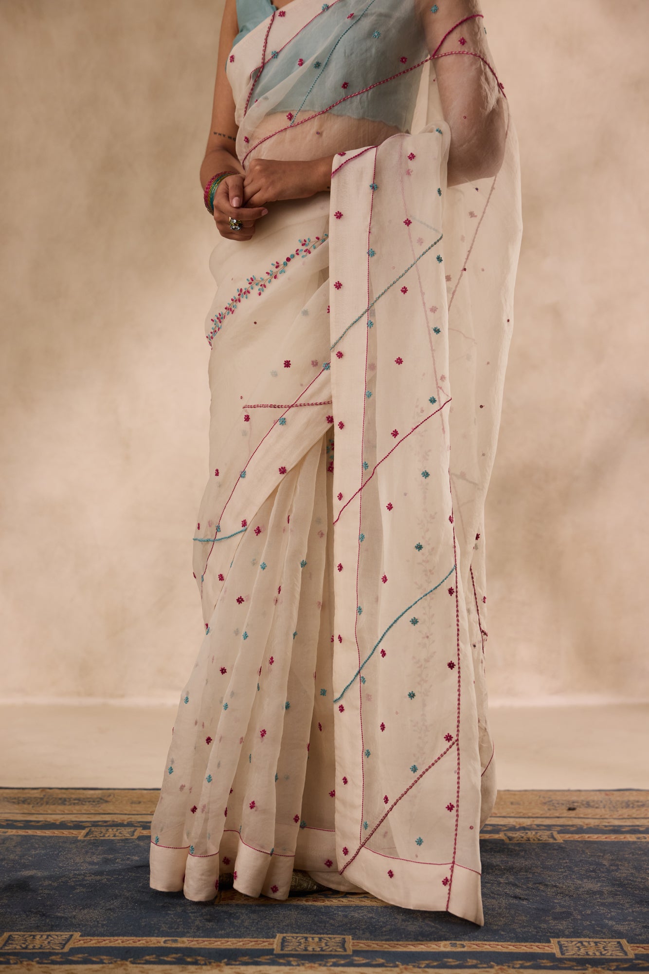 Ivory organza french knot cross stitch embroidered saree comes with unstitched & unembroidered blouse fabric in chanderi