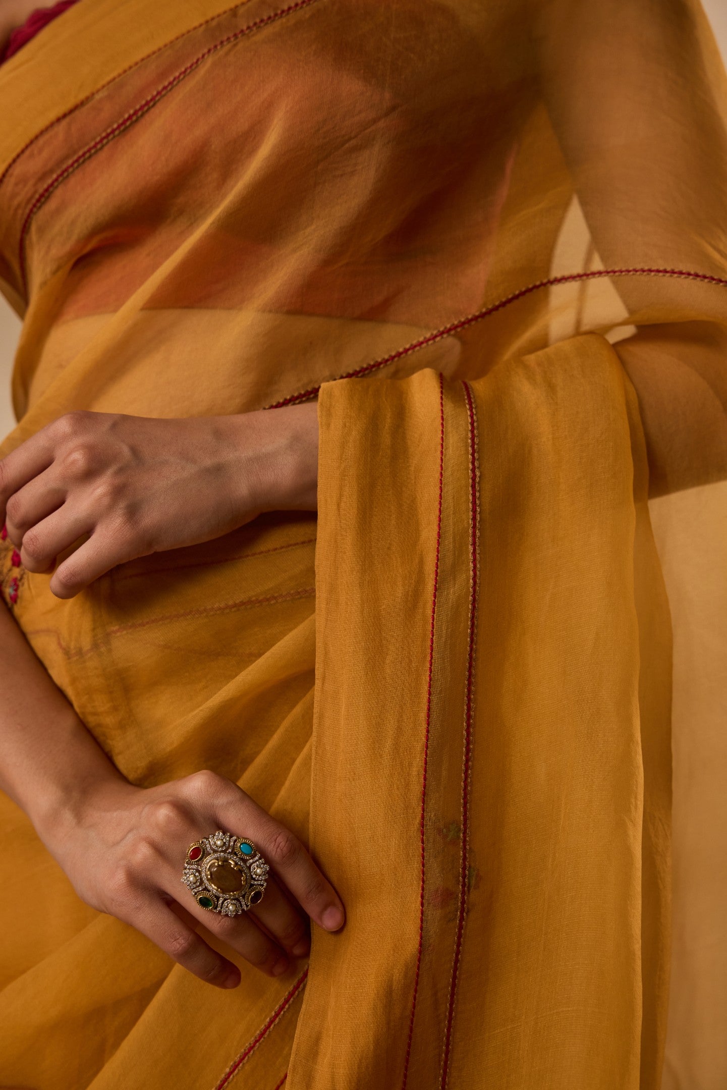 Mustard embroidered organza saree  paired with unstitched & unembroidered blouse fabric