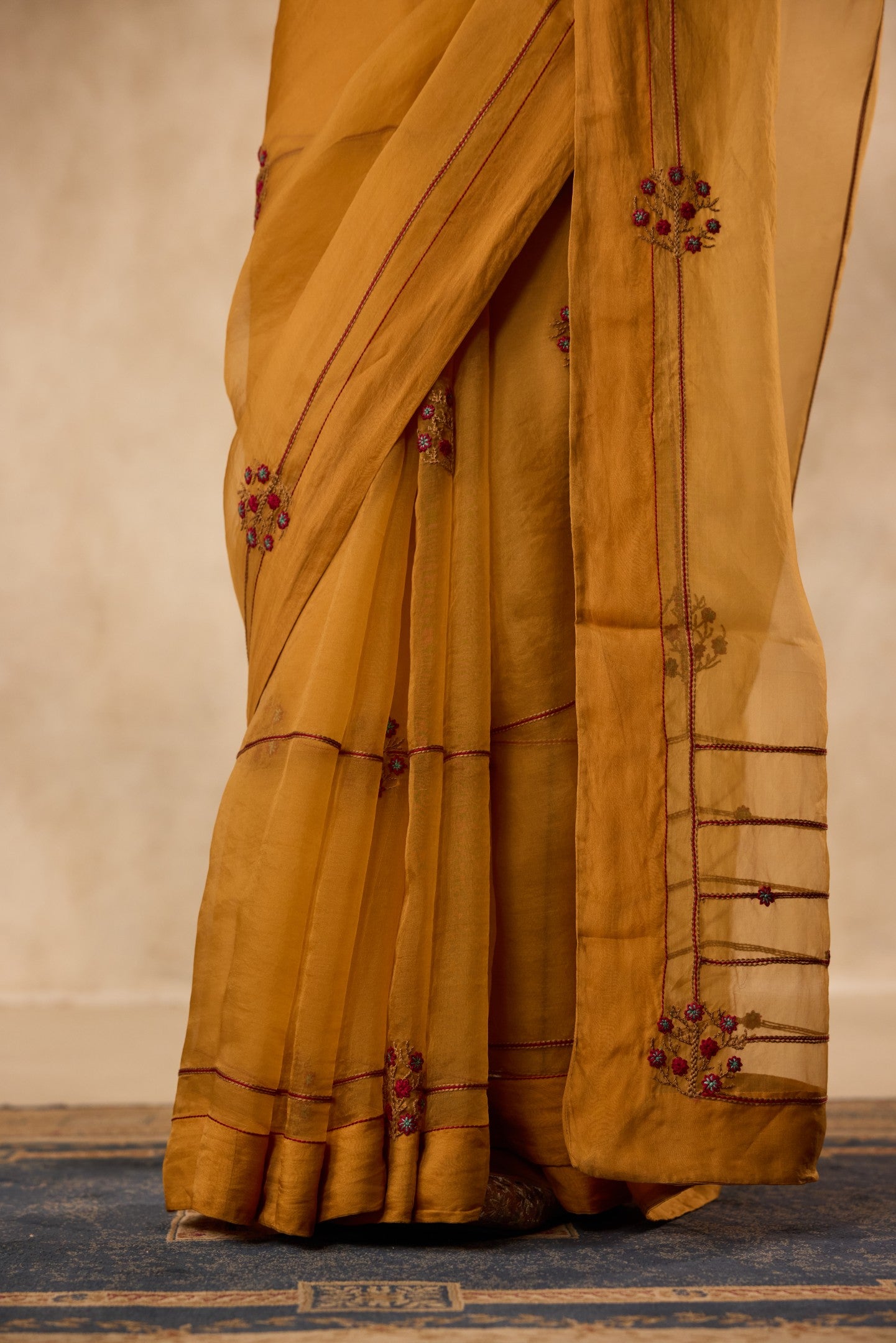Mustard embroidered organza saree  paired with unstitched & unembroidered blouse fabric